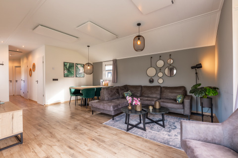 Lichte, moderne woonkamer in de Velthorst-lodge op Holiday park Aan de Maas, Nederland, met stijlvolle inrichting.