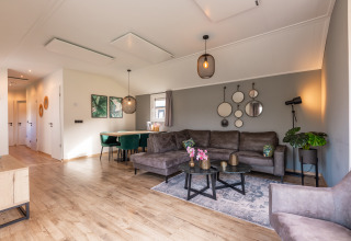 Lichte, moderne woonkamer in de Velthorst-lodge op Holiday park Aan de Maas, Nederland, met stijlvolle inrichting.