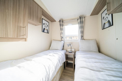 Habitación con dos camas individuales, armarios de madera y cuadros de panda en Berkel, Holiday park Aan de Maas.