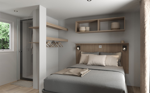Modern bedroom with double bed, open shelves and window at COTTAGE Premium, Campsite Le Château, France.