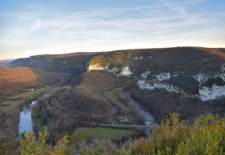 View of rolling hills and river near St Antonin Noble Val in Occitanie, France, during sunset.
