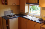 Küchenansicht im Mobile home Comfort auf dem Campingplatz La Grande Véyière mit Gasherd und Spüle.