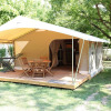 Glamping accommodation at Camping La Plage Vézac - Tentlodges Dordogne with deck and outdoor furniture.