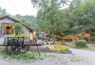 Scenic view of Campsite Moulin de Chaules in Auvergne-Rhône-Alpes, France, with lights and lush greenery.