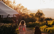 Two children in bathrobes walking at sunset near Campsite Lucherino, a holiday park in Tuscany, Italy.