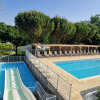 Swimming pool and waterslide at Les Coteaux du Lac glamping tents in the Loire, surrounded by greenery.