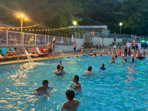 Evening by the pool at Campsite La Vallée Heureuse, Provence-Alpes-Côte d’Azur, France, with people swimming.