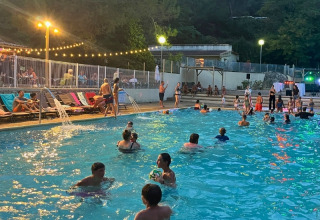 Evening by the pool at Campsite La Vallée Heureuse, Provence-Alpes-Côte d’Azur, France, with people swimming.