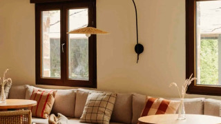 Cozy and modern lounge area at Wecamp Cudillero in Asturias, Spain, featuring wooden and woven furniture.