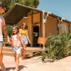 Family enjoying glamping at Devesa Gardens Camping & Resort near Valencia, Luxe safari tent shown.