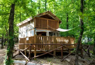 Airlodge 1 at Chianti Glamping Resort in Italy, a cozy wooden lodge surrounded by lush green forest.