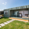Modern glamping accommodation at Camping Ballena Alegre - Mobile homes Girona with terrace and lounge chair.