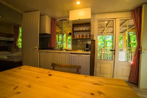 Vue intérieure d'une cuisine chaleureuse au Cottage Spotty du Chianti Glamping Resort en Italie.