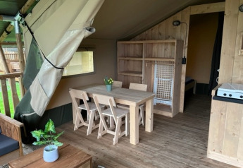 Interior of a safari tent with wooden furniture and sanitary facilities at Campsite de Zeven Heuveltjes, Netherlands.