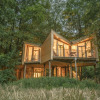 Treehouse glamping accommodation at Bio-hotel Kenner's Landlust in Lower Saxony, surrounded by forest.