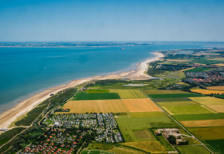 Aerial view of the coast near Cadzand, Zeeland, Netherlands with beaches, farmland, and towns nearby.