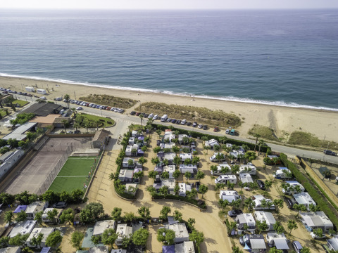 Aerial view of Campsite del Mar in Catalonia, Spain, showing motorhomes and pitches by the seaside beach.