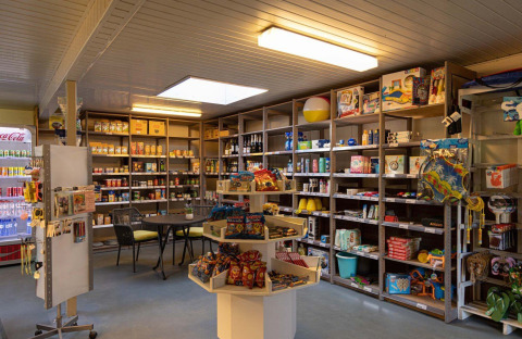 Shop at Campsite Roland in Limburg, Netherlands, with shelves stocked with snacks, toys, and essentials.