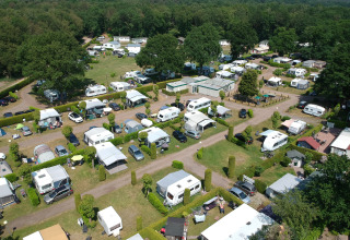 Aerial view of Campsite Roland in Limburg, Netherlands, showing caravans, tents, trees, and green areas.