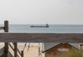 View from Beach Sleeping Cabin Strand Dishoek 342 in Dishoek, Netherlands, with ship and beach visible.
