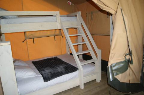 Interior of Safari tent WOOD at Campsite des Tourbières in France, featuring a cozy bunk bed setup.