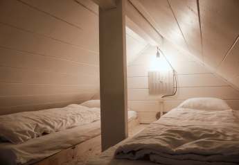 Two single beds in a small, renovated loft room at Basic cabin renovated - GENT in Urban-Gardens Gent, Belgium.
