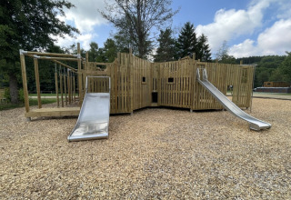 Playground with wooden structure and slides at Le Hameau de l'Ourthe holiday park, Belgium Luxembourg.