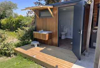 Barrierefreies Toilettenhäuschen mit Außenwaschbecken im Flower Camping Provence Vallée, Provence, Frankreich.