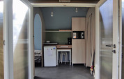 Entrance to a Coco Sweet safari tent at Family's Camping Le Savoy in France, with open doors and kitchenette.