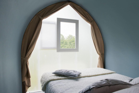 Interno della tenda safari Coco Sweet al Flower Camping Provence Vallée con finestra e due letti.