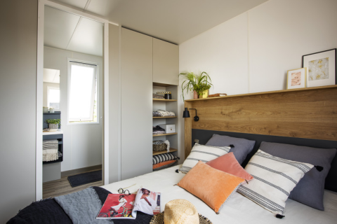 Modern bedroom inside Mobile Home «Living» at Flower Camping Provence Vallée, France, with cozy and stylish decor.