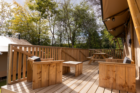 Terraza de madera con sillas y mesa de picnic en Stardust 40 Family Lodge, Arden Parks, Signy l'Abbaye, Francia.