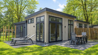 Bright Veldzicht lodge with modern patio, sun loungers, and outdoor dining, surrounded by lush trees.