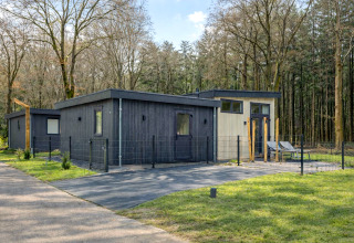Lodge moderno llamado Veldzicht en Forest Park Ede, Países Bajos, rodeado de árboles y naturaleza.