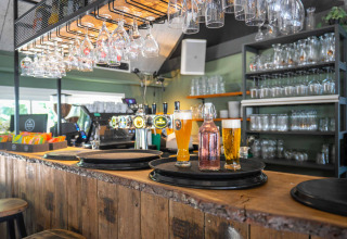 Billede af en bar ved Gooise Heide feriepark i Nordholland, Holland med glas, øl og flasker.
