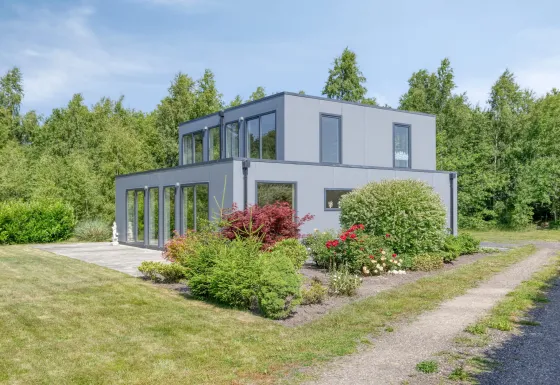 Villa BushBush lodge con sauna, edificio moderno a due piani immerso nel verde e circondato da giardino.