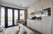 Modern kitchen and dining area inside Happy Oak wellnesslodge at Holiday park Mölke in the Netherlands.
