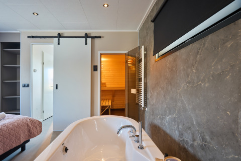 Moderne wellnesslodge med fritstående badekar, sauna og elegante detaljer ved Holiday park Mölke, Nederlandene.