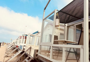 Row of modern beach cabins at Beach sleep house Dishoek 37, Zeeland, Netherlands, on a bright sunny morning.