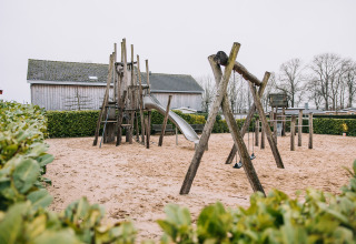 Aire de jeux avec structure en bois, toboggan et balançoires à la lodge Biebosch, Resort Mooi Bemelen, Pays-Bas.
