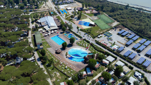 Aerial view of Campsite Spina Family Collection in Emilia-Romagna, Italy, showing pools and solar panels.