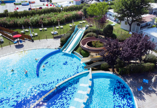 Aerial view of Spina Family Collection campsite in Emilia-Romagna, Italy, featuring pool and water slides.