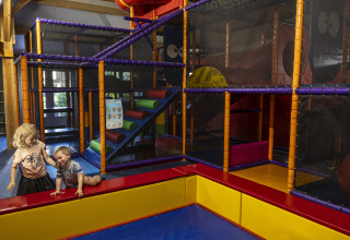 Kids playing in an indoor playground at the Beach house with hottub at Campsite 't Veld, Netherlands.