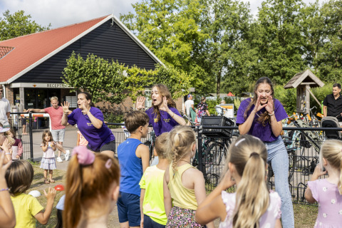 Children join outdoor activities led by entertainers at Beach house with hottub, Campsite 't Veld, Netherlands.