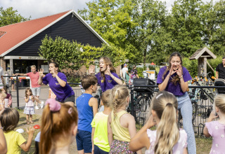 Children join outdoor activities led by entertainers at Beach house with hottub, Campsite 't Veld, Netherlands.