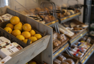 Fresh oranges and bread displayed in a chalet at Beach house with hottub at Campsite 't Veld, Netherlands.