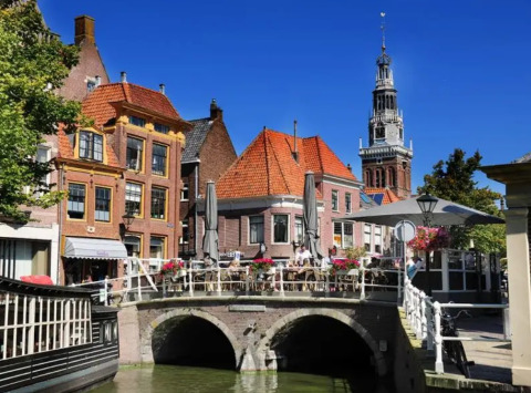 Charming canal view at Marina Uitgeest holiday park in North Holland, Netherlands with historic Dutch buildings.