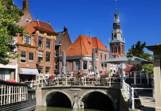 Charming canal view at Marina Uitgeest holiday park in North Holland, Netherlands with historic Dutch buildings.