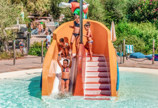 Children play on a water slide at the pool area of Campsite Rosselba le Palme, a holiday park in Tuscany, Italy.