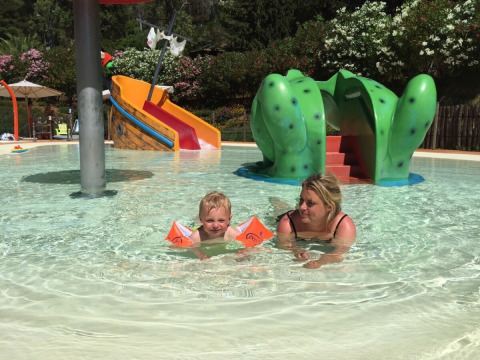 A child and woman swim together in the shallow pool at Rosselba le Palme Holiday Park in Tuscany, Italy.